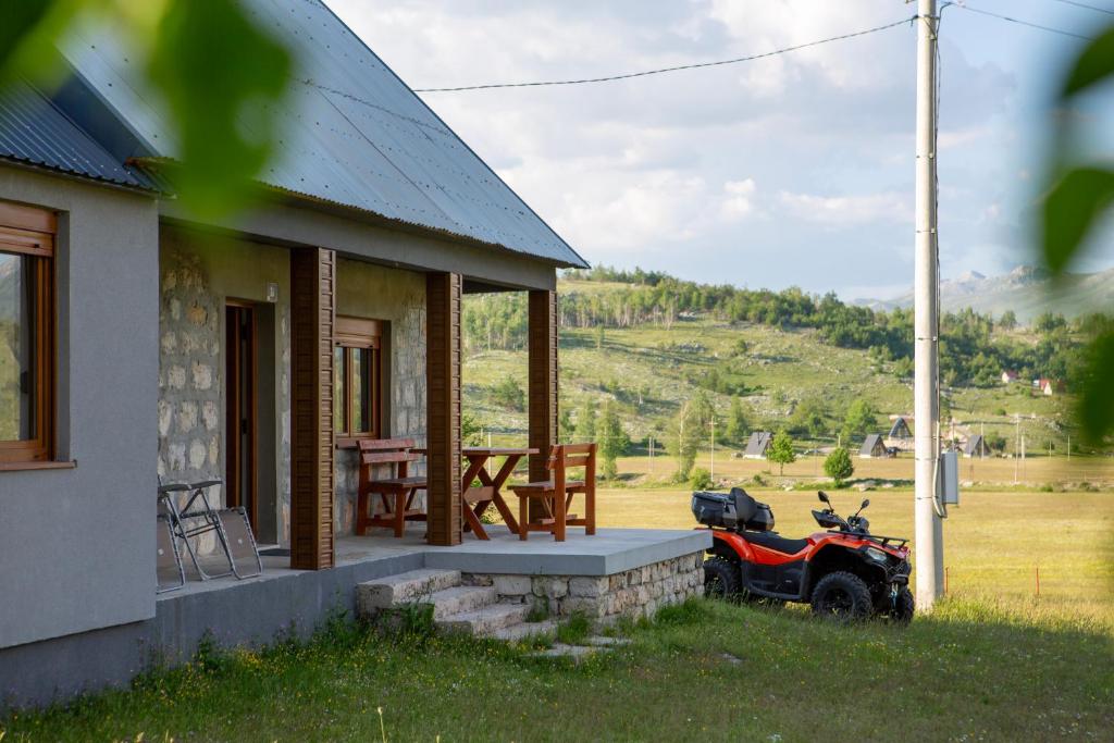 a motorcycle parked on the porch of a house at Mountain Home Zaborje in Plužine