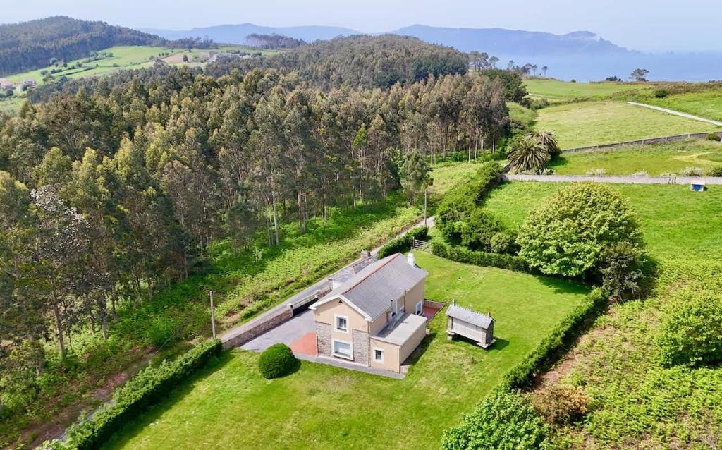 an aerial view of a house in a field at The Cliffs - Casa Cadaval in Santa Marta de Ortigueira