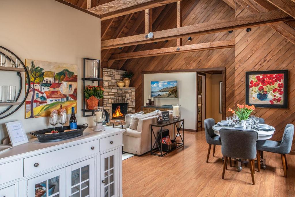 a kitchen and living room with a table and a fireplace at 3796 The Madden Suite in Carmel