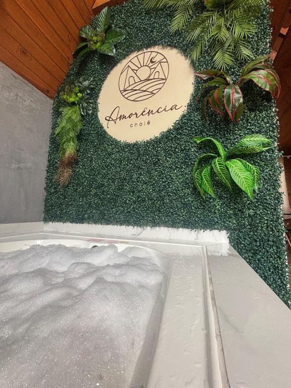 a display of a spa with plants and a sign at Amorência Chalé Luz da lua in Campo Largo