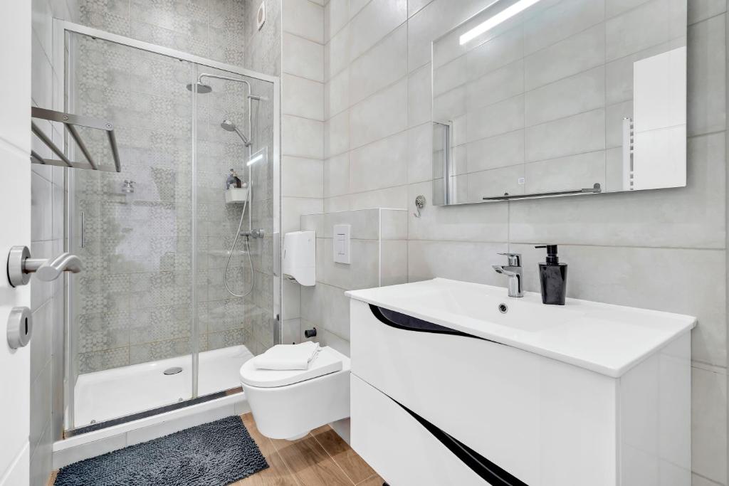 a bathroom with a toilet and a sink and a shower at Résidence Welter Luxembourg in Luxembourg