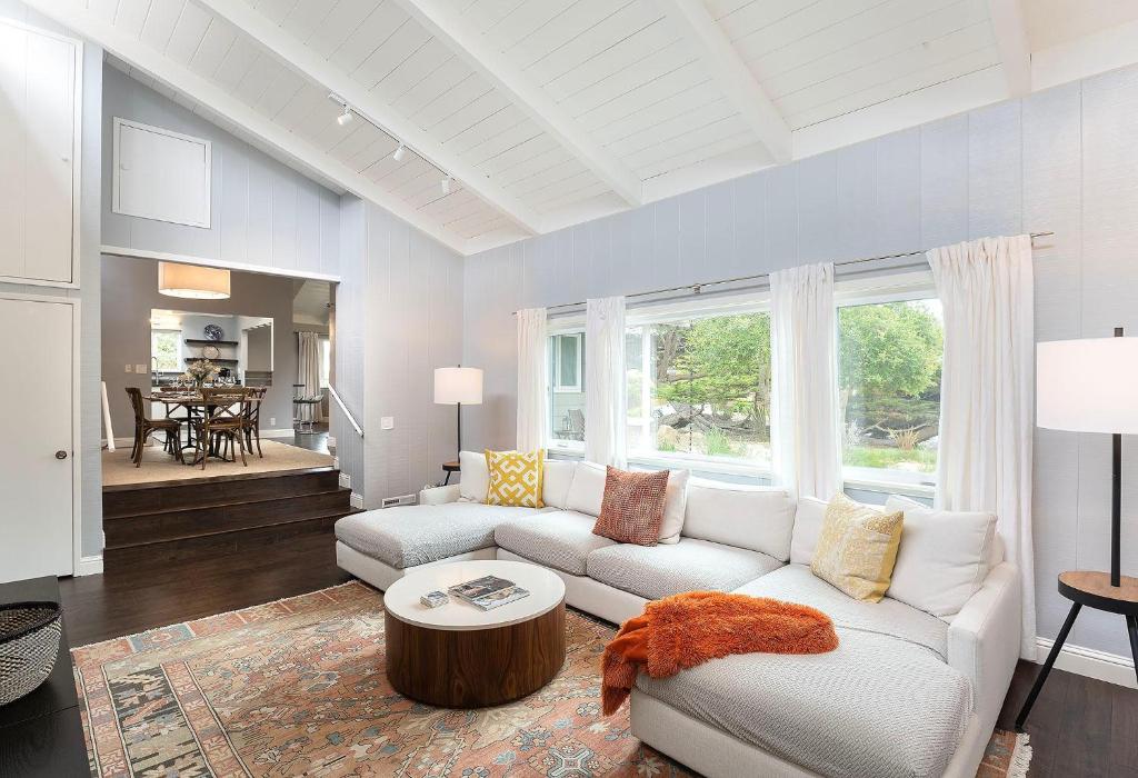 a living room with a white couch and a table at 3890 Cypress Rest in Pebble Beach