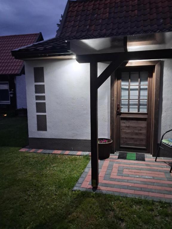 a front door of a house with a porch at Noclegi Radoch Mazury in Ruciane-Nida
