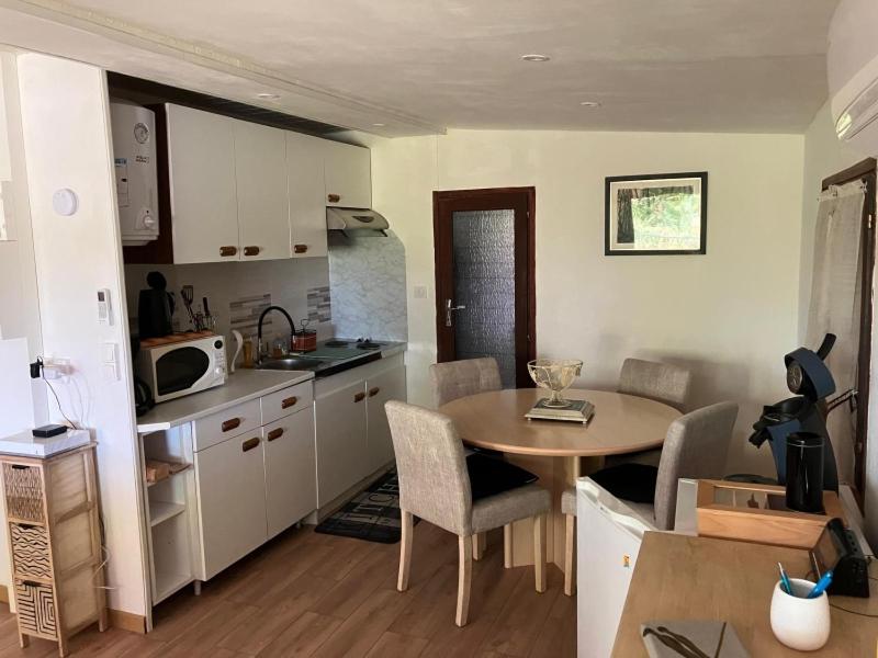 a kitchen with a table and a small table and chairs at Gîte chez Kus in Changey