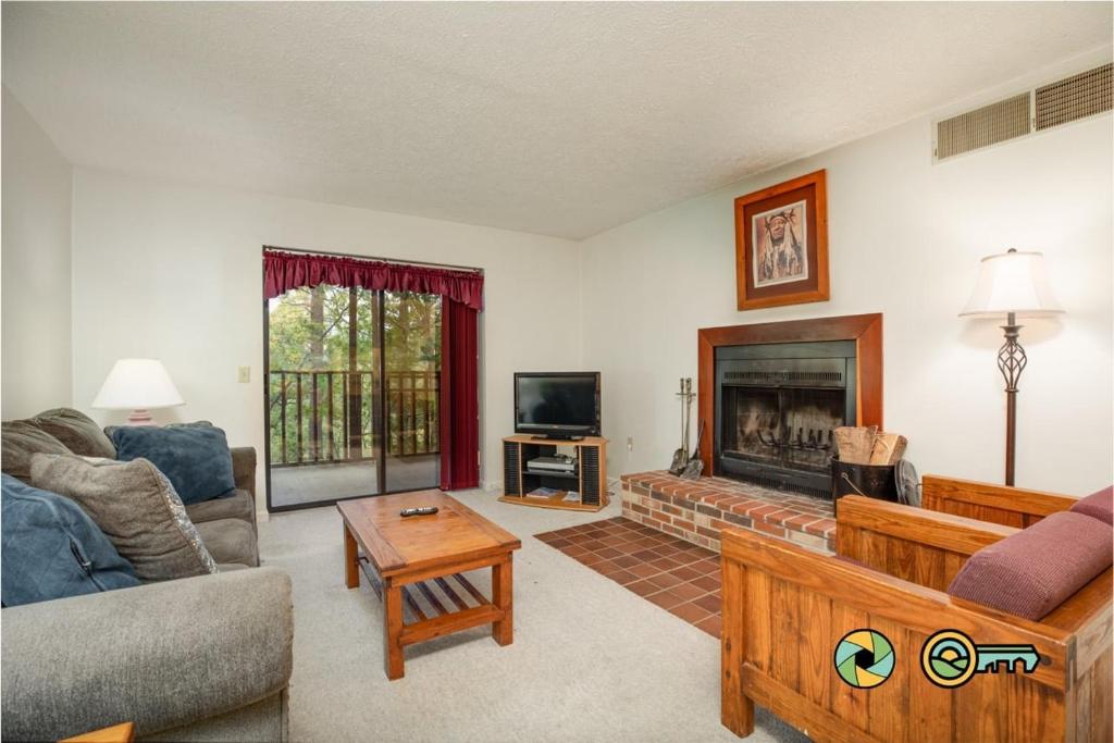 a living room with a couch and a fireplace at Senedo Springs Condo #2-202 in Basye