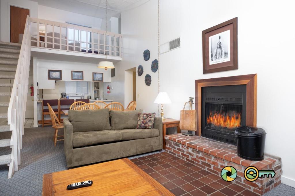 a living room with a couch and a fireplace at Senedo Springs Condo #2-301 in Basye