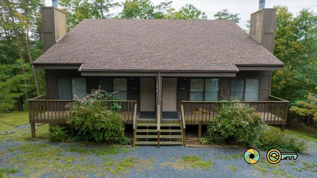 a small house with a porch and a roof at Senedo Springs Duplex #90A in Basye
