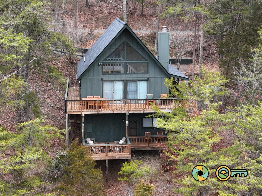 a house with two dogs sitting on a deck at 210 Nelson Way: Par Pine Lodge in Basye