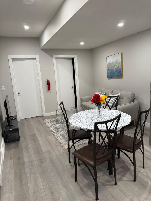 a dining room with a table and chairs and a couch at A place to call a home in YYC