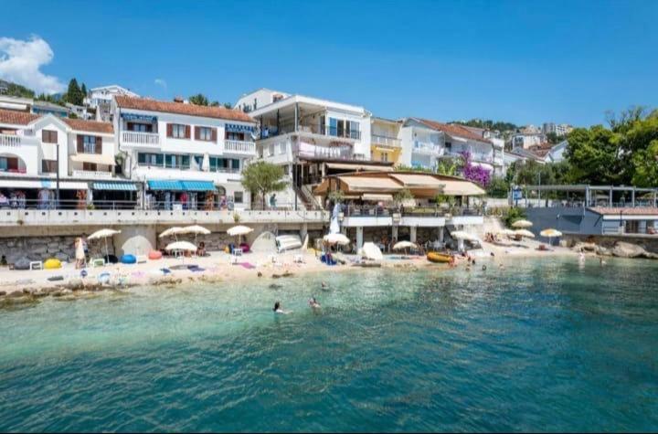 a group of people in the water at a beach at Apartmani Cebra & Lisa in Topla