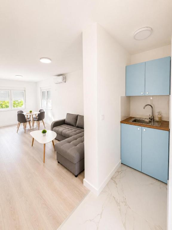 a living room with a couch and a table at White House apartmani in Vrdnik