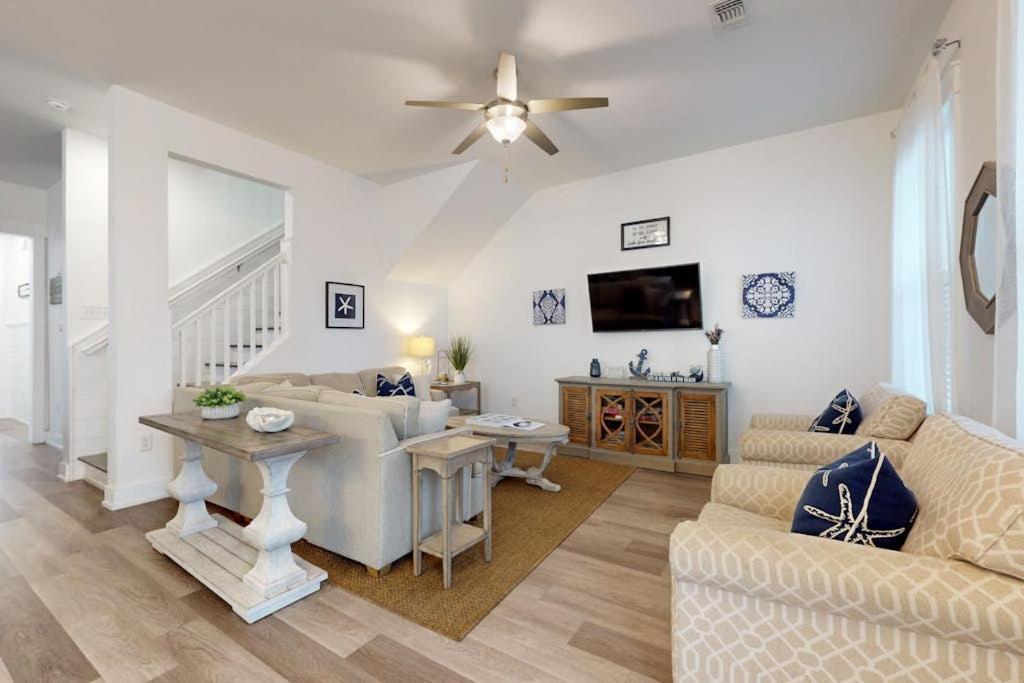 a living room with a couch and a table at New-Build with Pool Walk to Beach in Santa Rosa Beach