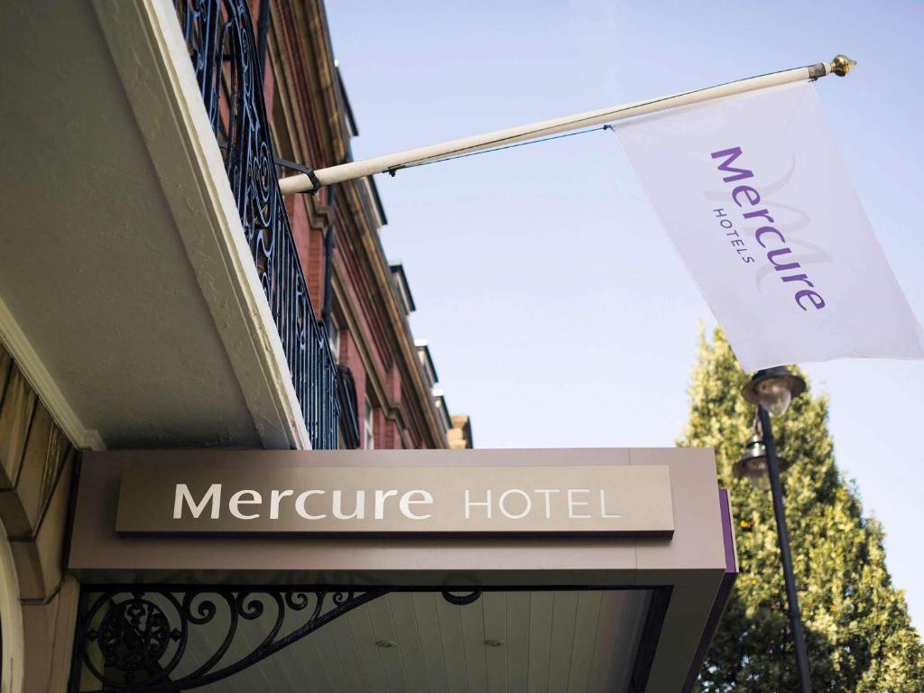 a sign for a mercure hotel with a flag at Mercure Doncaster Centre Danum Hotel in Doncaster