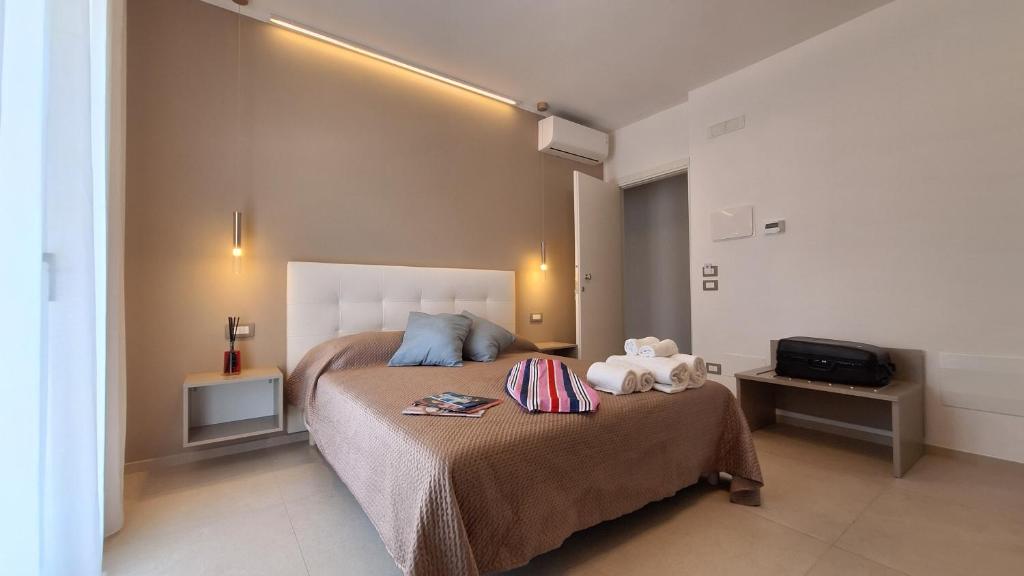 a bedroom with a large bed and a television at Venti del Sud in Vieste