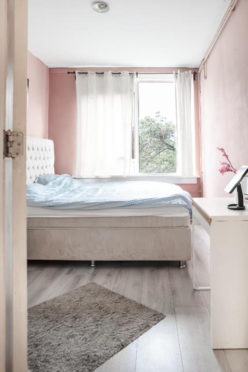 a bedroom with a bed and a window at The Hague appartment in The Hague