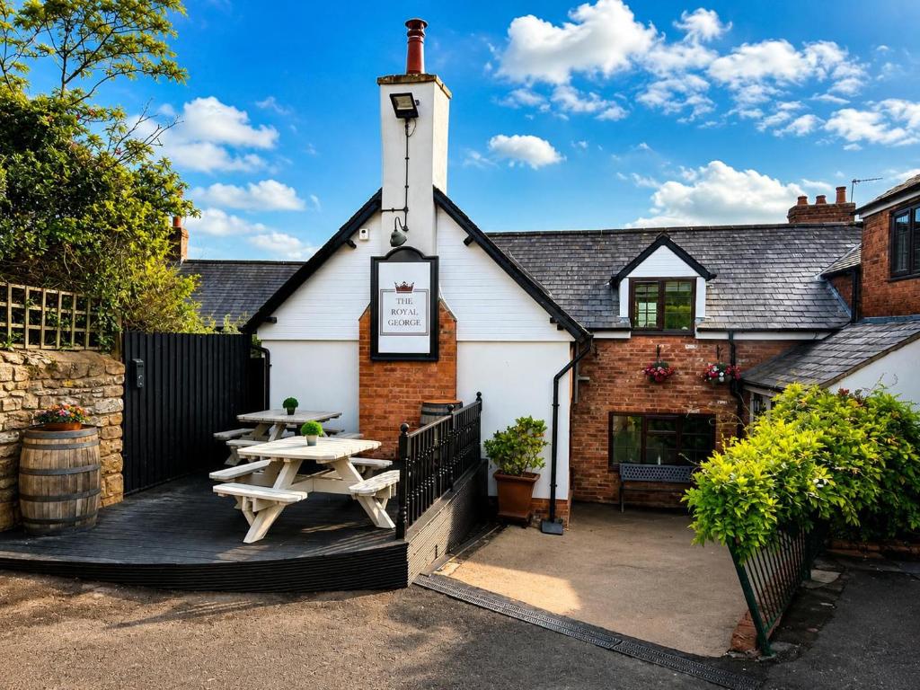 a pub with a picnic table in front of it at The Royal George Cottingham in Cottingham
