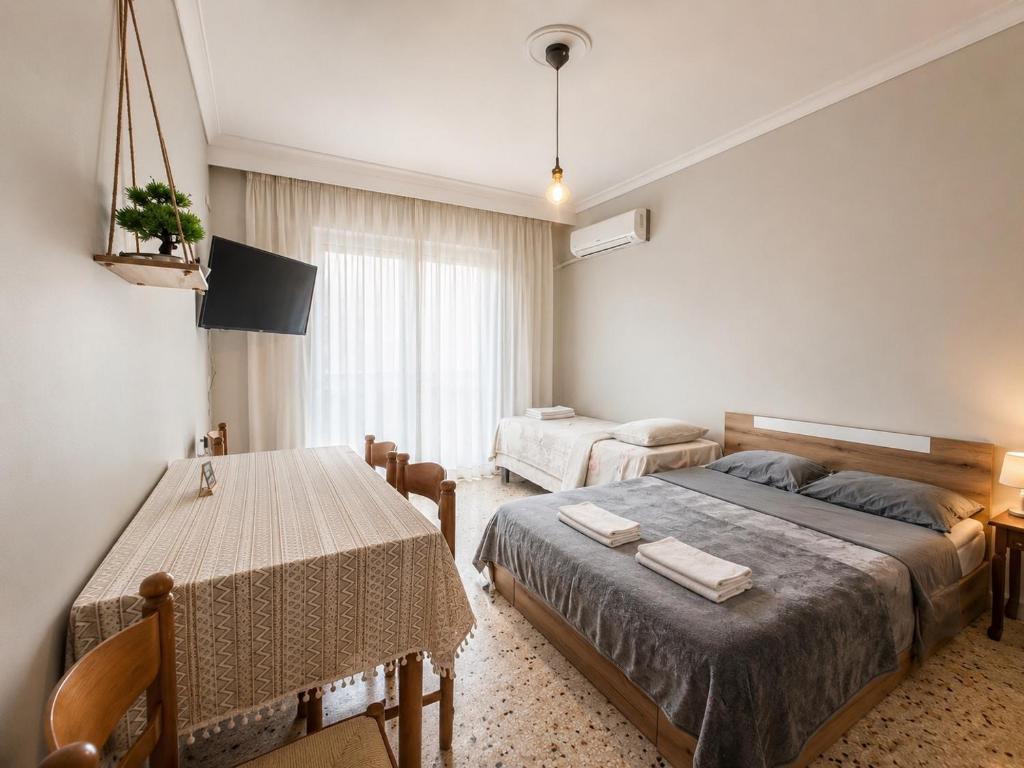 a bedroom with a bed and a table in it at Karma Seaside Apartment in Perea