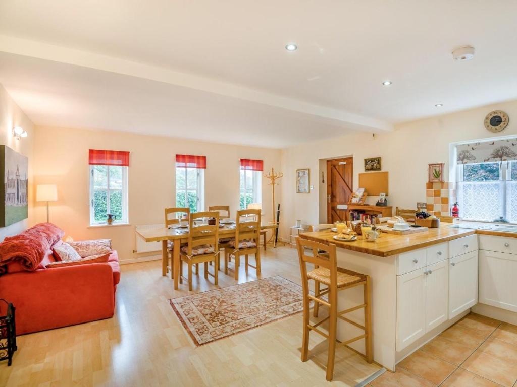 a kitchen and living room with a red couch at 2 Bed in Monmouth oc-93650 in Trelleck