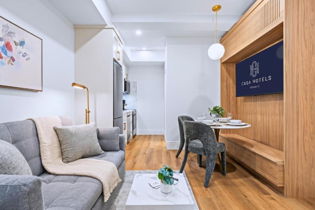 a living room with a couch and a table at Casa Hotels Gerrard Private Basement Suite in Toronto