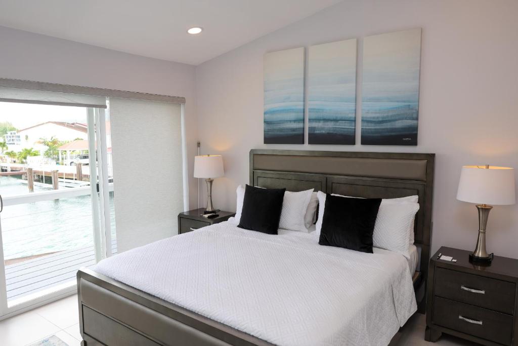 a bedroom with a bed with white sheets and pillows at 232D South Finger in Jolly Harbour