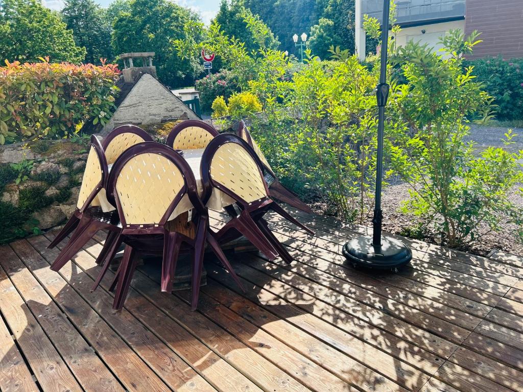 a group of four chairs sitting on a deck at Gîtel'harmonie2 in Fraize