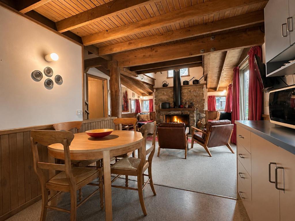 a kitchen and dining room with a table and chairs at Bindi - Alpine Getaways's Chalet at Tower Rd in Dinner Plain