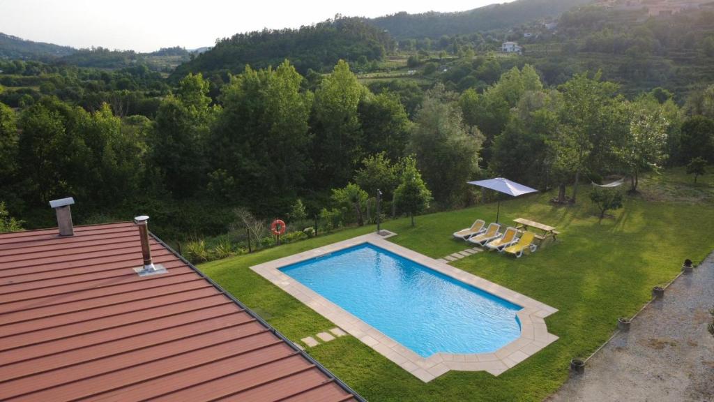 an overhead view of a swimming pool in a yard at Casa Terra Nova - Gerês in Terras de Bouro