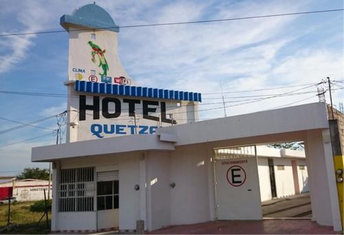 a hotel with a sign on top of a building at Hotel Posada Quetzal in Arriaga