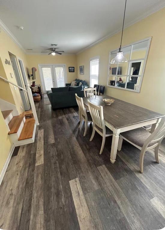 a dining room and living room with a table and chairs at Charming Key West Rental in Key West