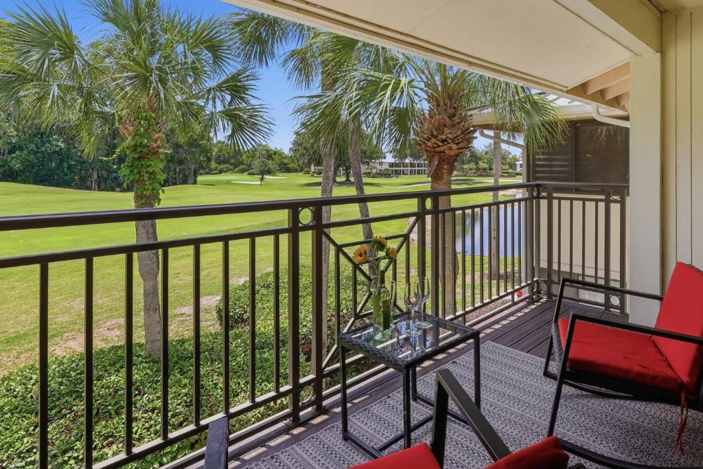 a balcony with a table and chairs and a golf course at 14th Hole Golf Course Views! in Wesley Chapel