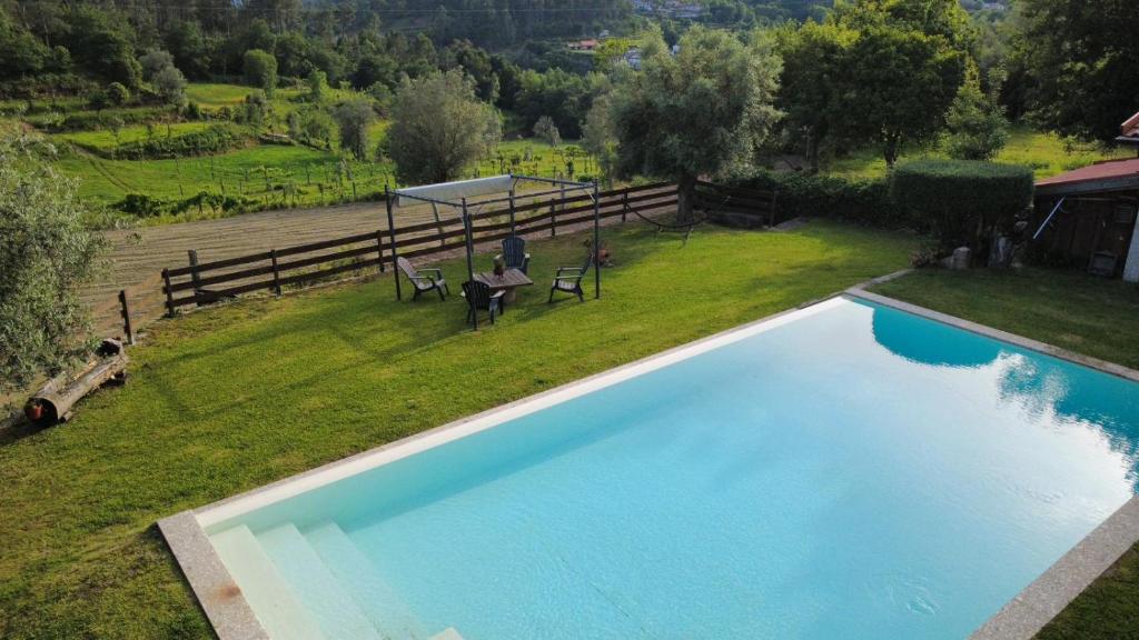 an overhead view of a swimming pool in a backyard at Quinta do Paço - Casa do Caseiro in Vila Verde