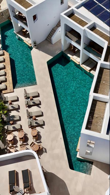 an overhead view of a swimming pool with lounge chairs at Nuca Mykonos Hotel in Platis Gialos