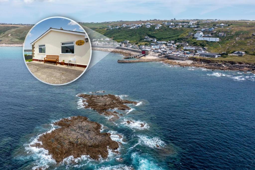 a house on a small island in the water at 3 Bed in Sennen Cove oc-p00781 in Sennen