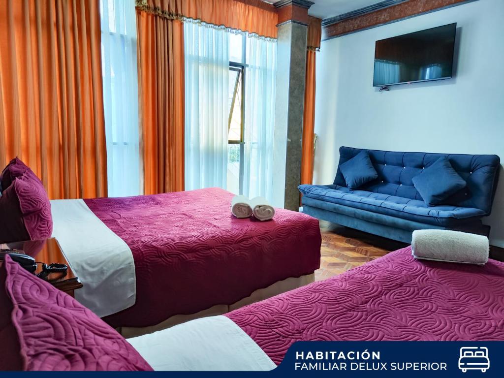 a hotel room with two beds and a couch at Hotel Diamante Azul in La Paz