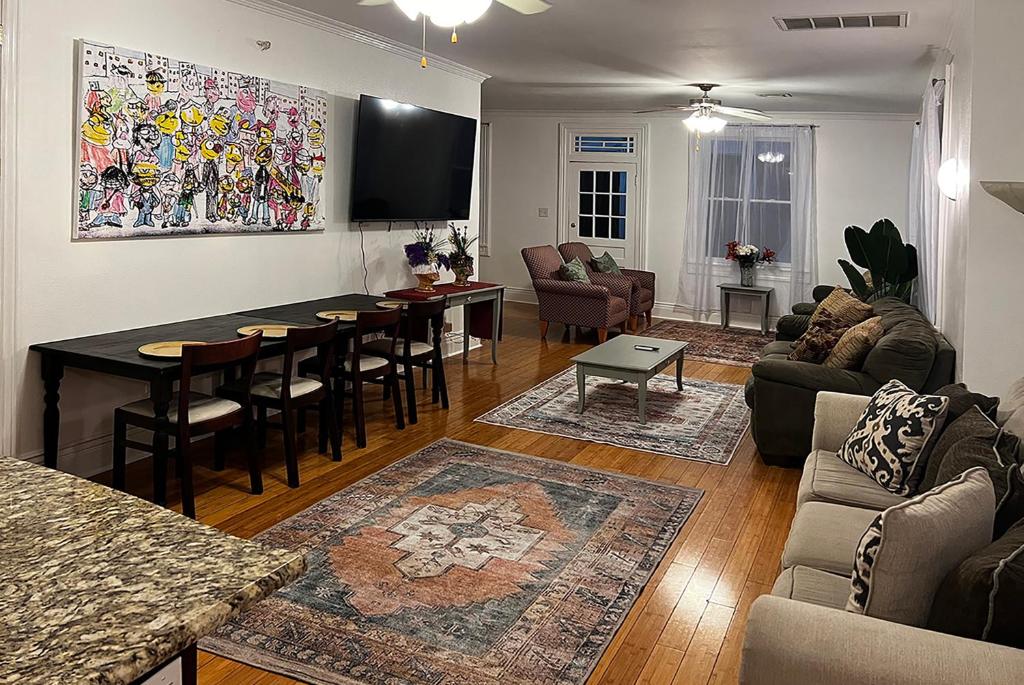 a living room with a couch and a table at Spacious Napoleon Ave Condo in New Orleans