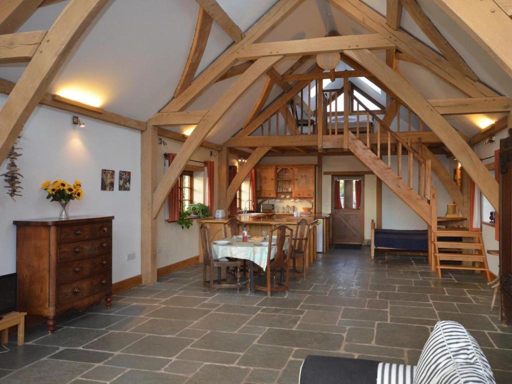 a large room with wooden ceilings and a table and chairs at 1 Bed in Somerton oc-asher in Compton Dando