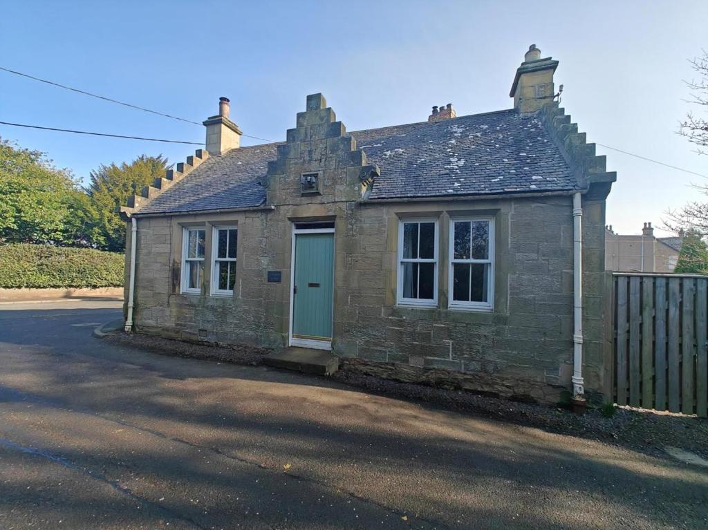 an old stone house with a blue door at 1 Bed in Duns oc-83140 in Duns