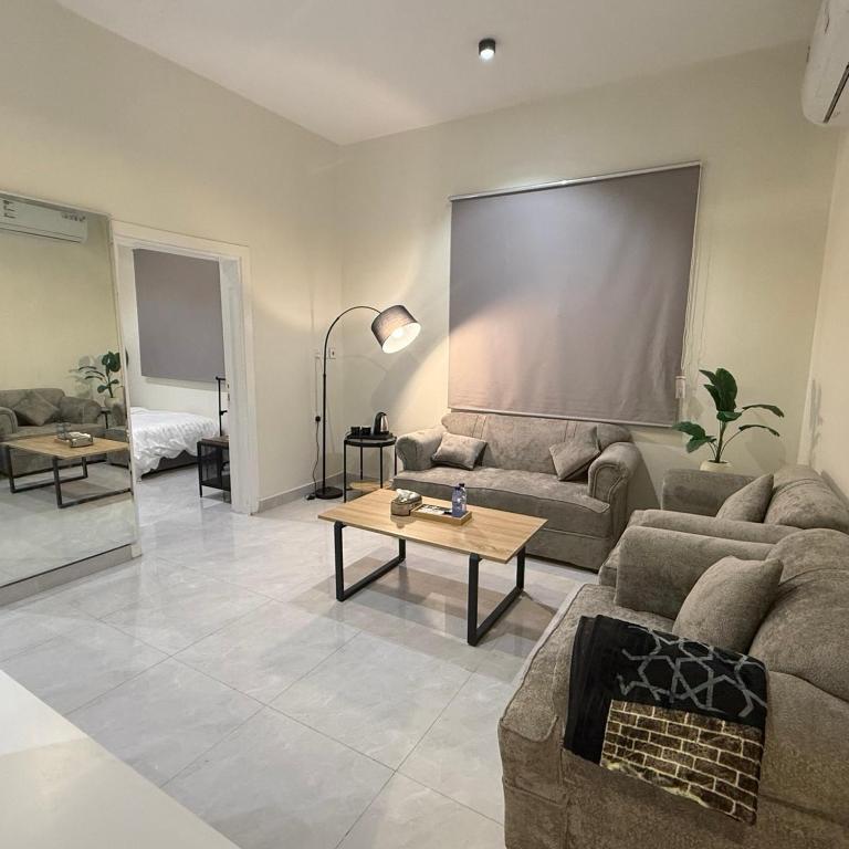 a living room with a couch and a table at أجنحة السمو in Hail