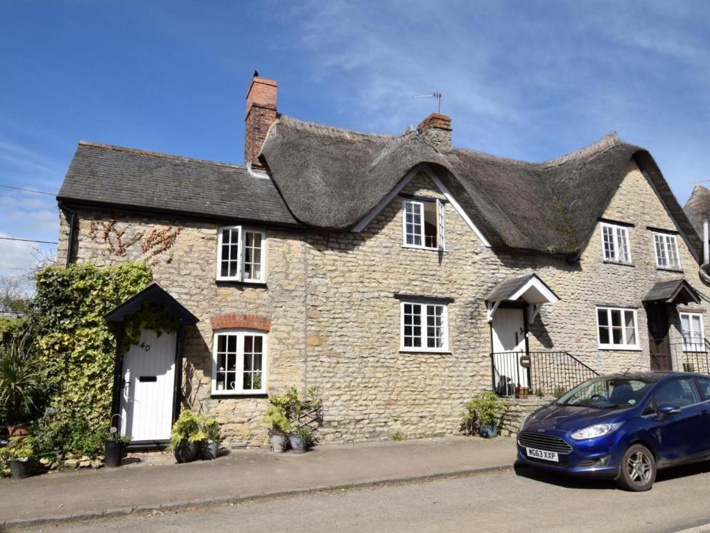 a house with a car parked in front of it at 1 Bed in Sherborne oc-51018 in Bradford Abbas