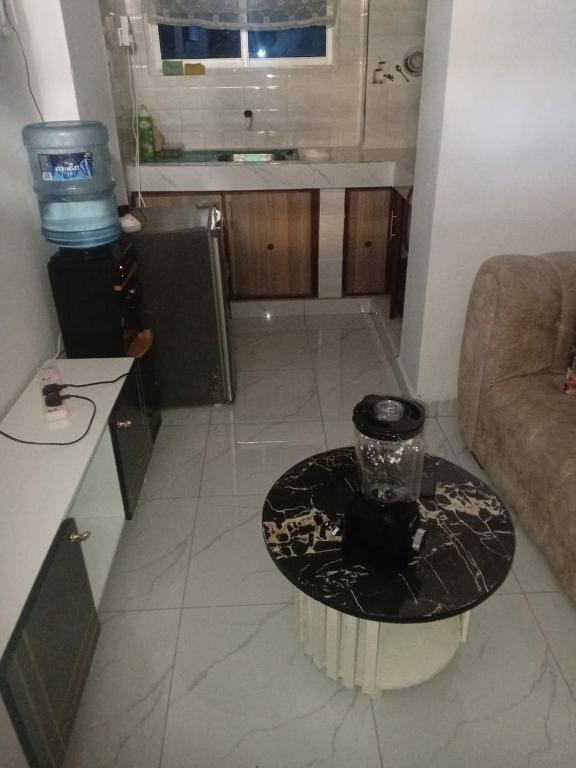 a living room with a table and a couch at Lila Homes in Bamburi