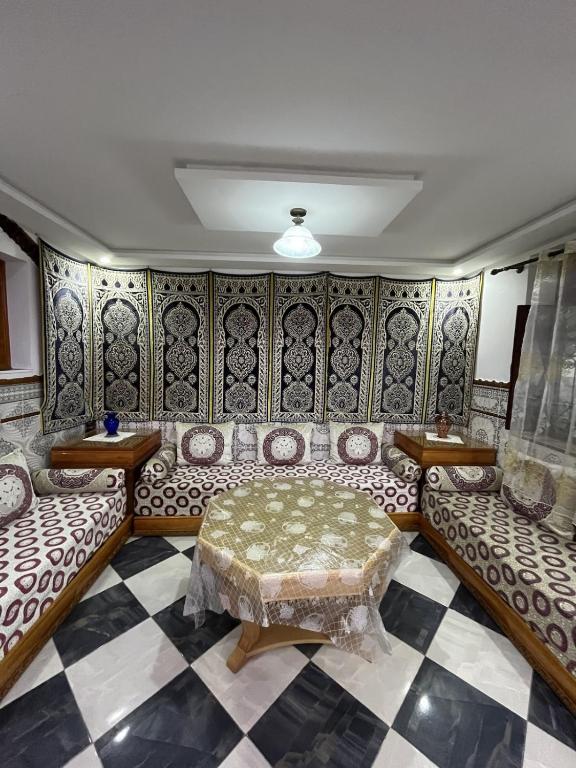a living room with a couch and a table at Casa Barkouk Central Chefchaouen Apartment in Chefchaouen