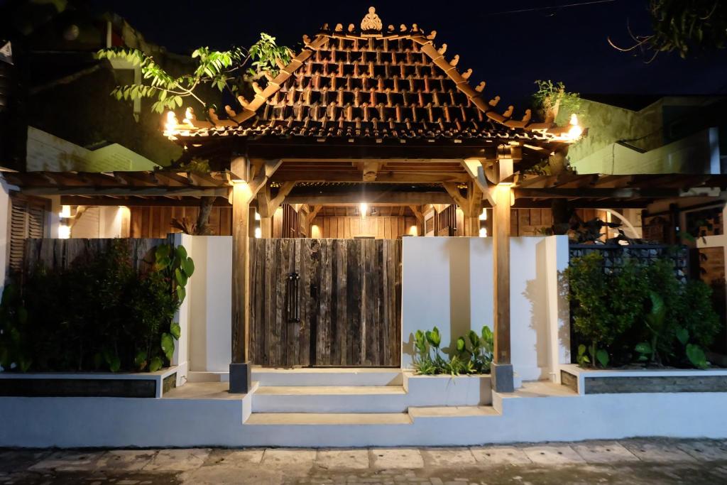 a gazebo with a chinese roof at night at Jagadhita Villas in Sekatonan