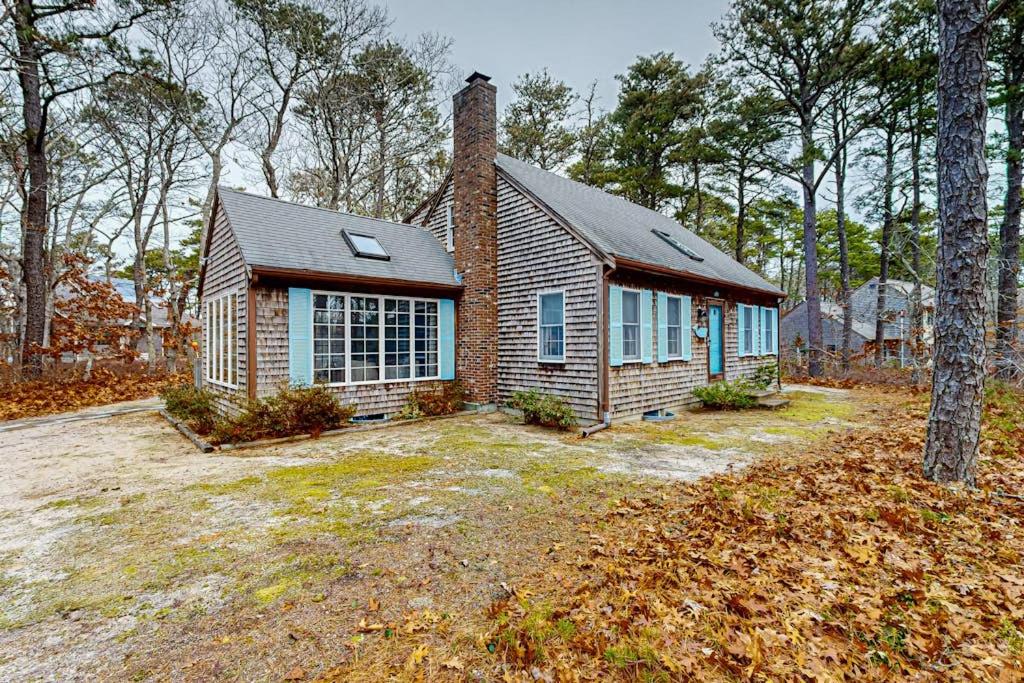a brick house with a chimney on a yard at Serene Cape Escape in Wellfleet