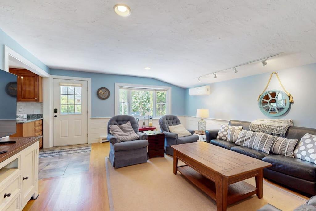 a living room with a couch and chairs and a table at Brewster Getaway in Brewster