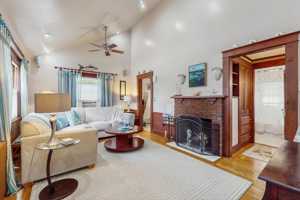 a living room with a couch and a fireplace at Mermaid Cottage in Falmouth