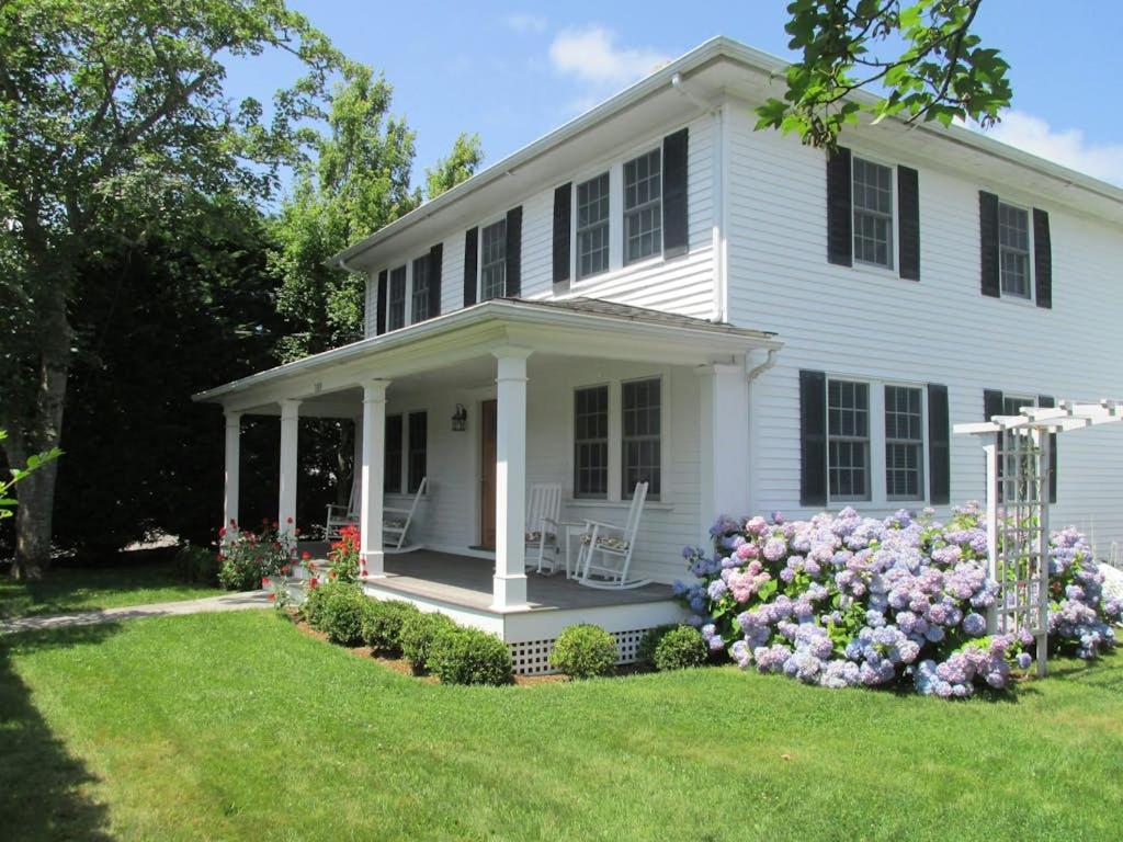 a white house with flowers in the yard at Edgartown Village in Edgartown