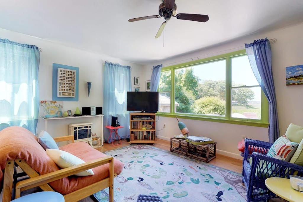 a living room with a couch and a tv at Sunset Meadows in Oak Bluffs