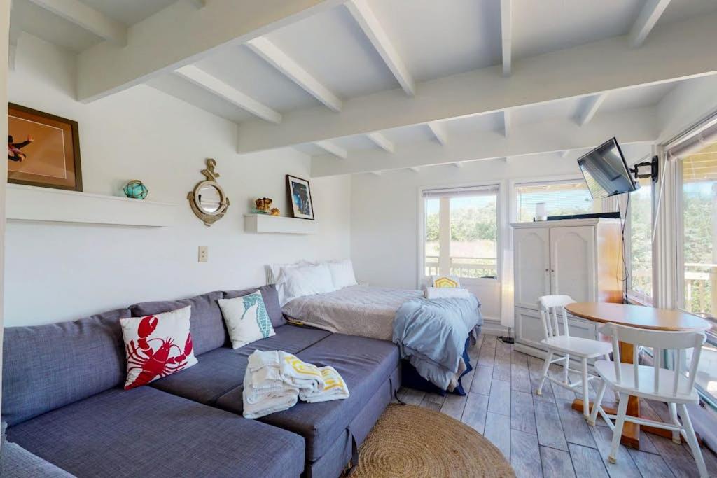 a living room with a couch and a bed and a table at Sand & Beach Within Reach in North Truro