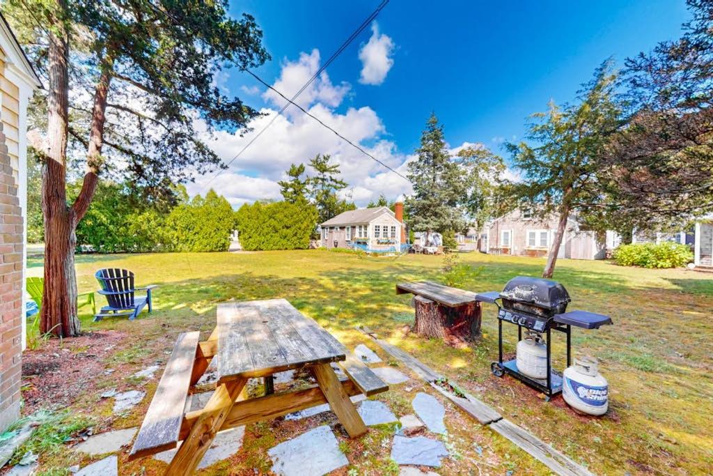 a backyard with a picnic table and a grill at The Spray in Harwich Port