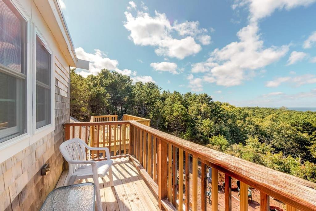 a porch with a bench and a view of the ocean at Bayview in Truro